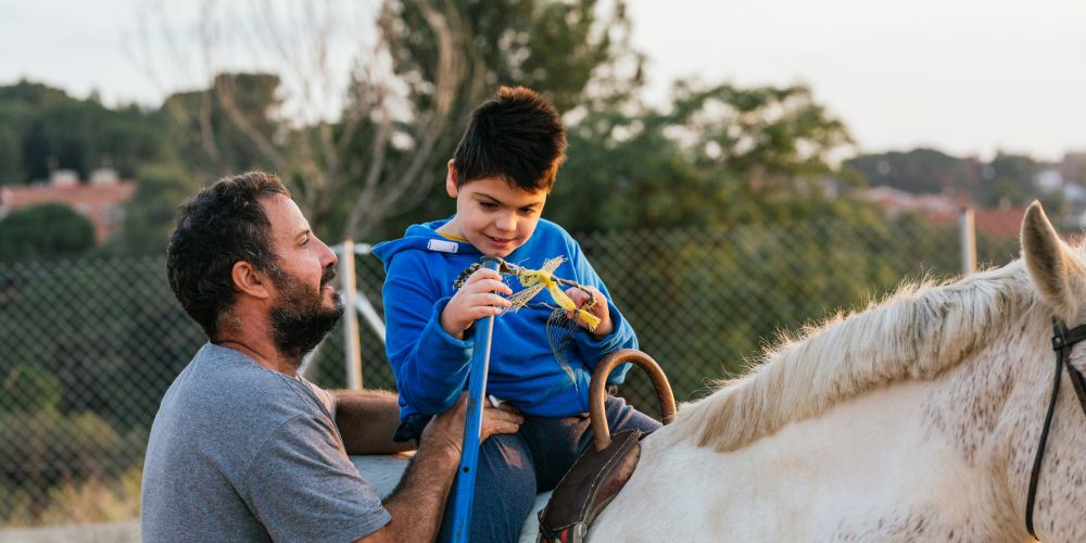 Discover how StreamZ supports NCEFT therapy heroes, boy on horse having fun